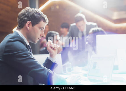 Serious businessman working at laptop in office Stock Photo