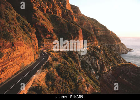 Road winding along side of mountain overlooking ocean. Mountain pass, Western Cape, South Africa, Africa Stock Photo