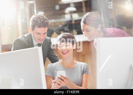 Business people texting with cell phone in office Stock Photo