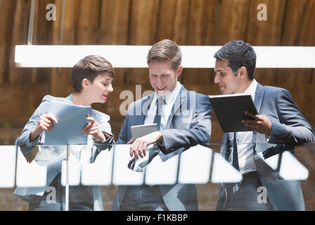 Business people with digital tablet on office balcony Stock Photo