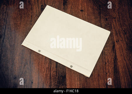 Just a classical white folder on wooden table. Stock Photo