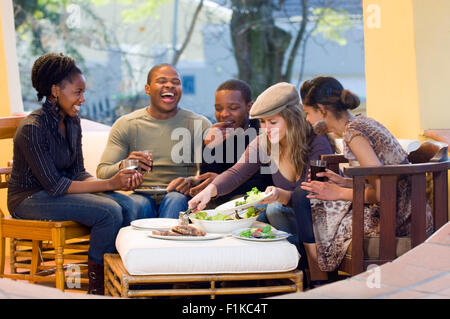 Friends having lunch, laughing Stock Photo