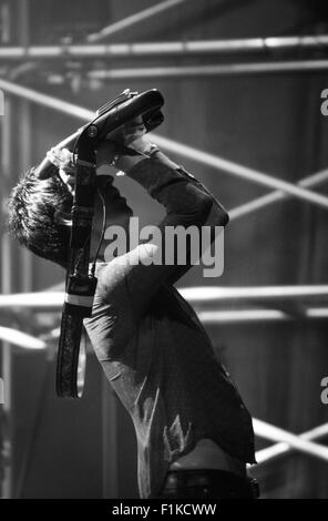 Johnny Marr at Victorious Festival 2015 holding his guitar over his head at the end of the gig. Suitable copy space. Stock Photo