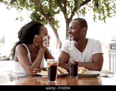 Young African couple sitting at a street-side restaurant, Newtown Johannesburg Stock Photo