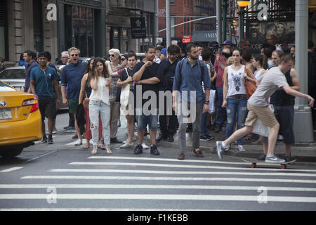 People cross Broadway in the hip SOHO neighborhood along Broadway in New York City. Stock Photo