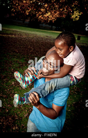 Young African Father playing in a park with his daughter Stock Photo