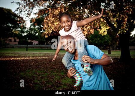 Young African Father playing in a park with his daughter Stock Photo