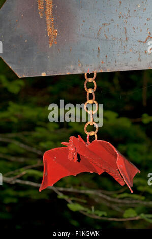 Art metal piece, red bat, in a signpost for a mountains route, designde by Koldobika Jauregi, on Ernio. Alikza. Gipuzkoa. Basque Stock Photo