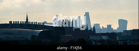 City of London skyline in silhouette behind St Pancras station, viewed from Mornington Crescent. Stock Photo