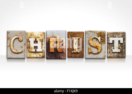 The name  'CHRIST' written in rusty metal letterpress type isolated on a white background. Stock Photo