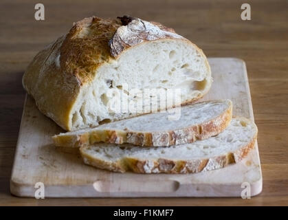 A loaf of bread partially sliced Stock Photo