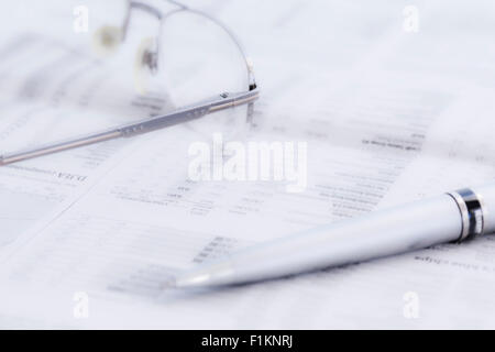 Business newspaper and glasses Stock Photo
