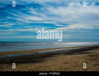 A landscape view of Ulrome beach ,Yorkshire, UK on a summers day with the tide far out.