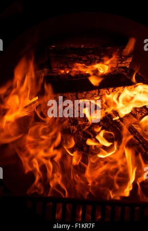 Fireplace Flames in the Dark. Fireplace Closeup. Stock Photo