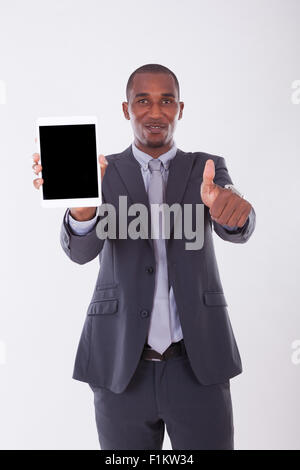 African american business man using a tactile tablet over white background - Black people Stock Photo