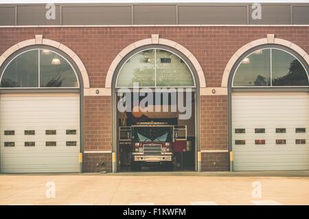 Firefighters of Colorado. Fire Truck inside Firehouse. Large Colorado Flag on the Wall. Colorado Fire Department. Stock Photo
