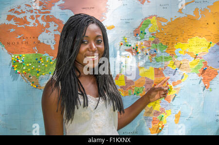 Beautiful African American women smiling in front of the world map. Global Village Festival, Boise, Idaho, USA Stock Photo