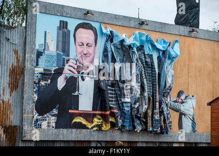 Street artist Banksy's Dismaland in Weston-Super-Mare. Pictured is piece featuring Prime Minister David Cameron on a billboard. Stock Photo