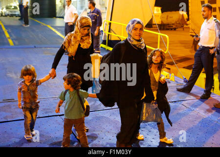 Piraeus, Greece. 03rd Sep, 2015. Two women disembark with their children from the Tera Jet ferry that has brought them from the island of Lesbos to Piraeus. Thousands of refugees arrived in Piraeus Harbor on board the government chartered Tera Jet ferry from the Greek Island of Lesbos. Hundreds of refugees mostly from Syria and Afghanistan arrive on the Greek Islands every week, adding to the thousands of refugees already on the Greek Islands. Credit:  Michael Debets/Pacific Press/Alamy Live News Stock Photo