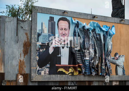 Street artist Banksy's Dismaland in Weston-Super-Mare. Pictured is piece featuring Prime Minister David Cameron on a billboard. Stock Photo