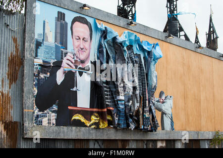 Street artist Banksy's Dismaland in Weston-Super-Mare. Pictured is piece featuring Prime Minister David Cameron on a billboard. Stock Photo