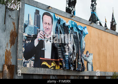 Street artist Banksy's Dismaland in Weston-Super-Mare. Pictured is piece featuring Prime Minister David Cameron on a billboard. Stock Photo