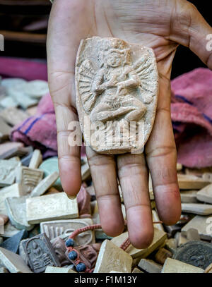 Amulet for sale at a street market in Bangkok, Thailand. 1 December, 2011. Stock Photo