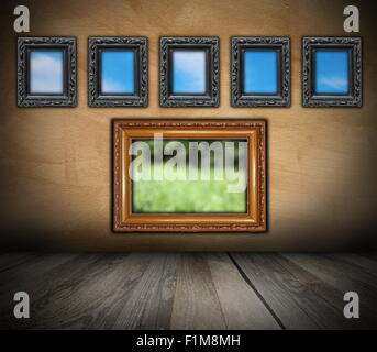 vintage interior backdrop with ancient wooden frames on grunge wall for your design Stock Photo