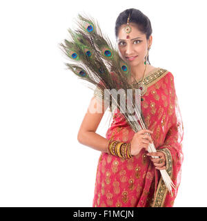 Portrait of beautiful Indian woman holding peacock feathers, isolated on white background. Stock Photo