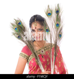 Portrait of beautiful young Indian girl holding peacock feathers, isolated on white background. Stock Photo