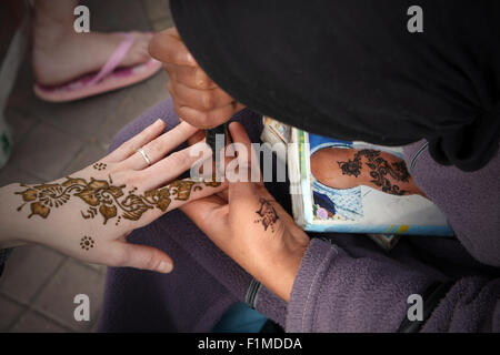 Moroccan woman making henna in Djemaa-El -Fna.Marrakesh,Morocco Stock Photo