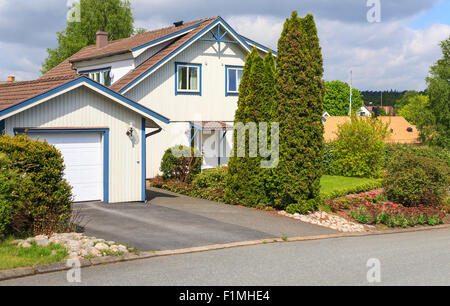 Typical swedish detached middle class wooden house and garage in Mölndal, Sweden  Model Release: No.  Property release: No. Stock Photo