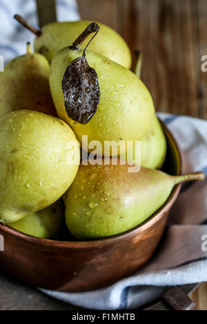 Fresh pears on a copper casserole. Stock Photo