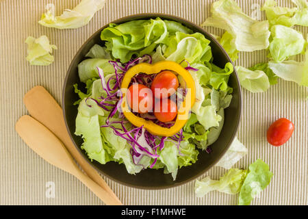 Salad with various kind of vegetables in bowl on table. Stock Photo