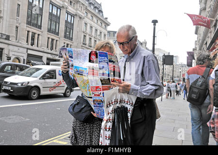 London, England, UK. Couple of tourists looking at a map in Whitehall Stock Photo