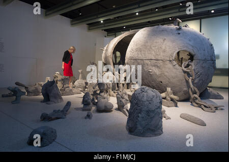 Kassel, Germany. 04th Sep, 2015. A visitor looks at the art work 'Maerchenbombe' (lit. Fairytale bomb) by the artists Lutz & Guggisberg on the opening day of the new exhibition house 'Grimmwelt' (lit. Grimm world) in Kassel, Germany, 04 September 2015. The new Grimm museum opens after two years of construction works. Photo: Swen Pfoertner/dpa/Alamy Live News Stock Photo