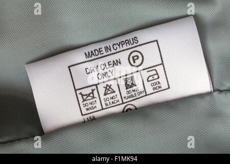 label in garment - Made in Cyprus dry clean only - sold in the UK United Kingdom, Great Britain - care washing symbols and instructions Stock Photo
