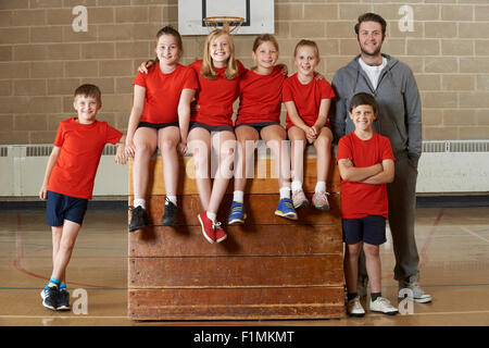 Portrait Of School Gym Team Sitting On Vaulting Horse Stock Photo