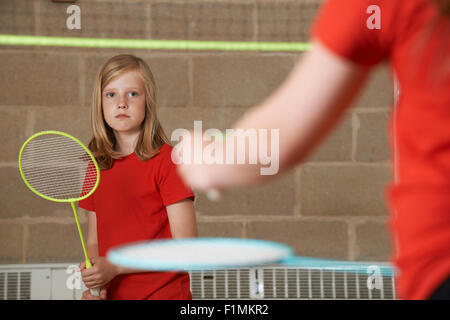 Two Girl Playing Badminton In School Gym Stock Photo