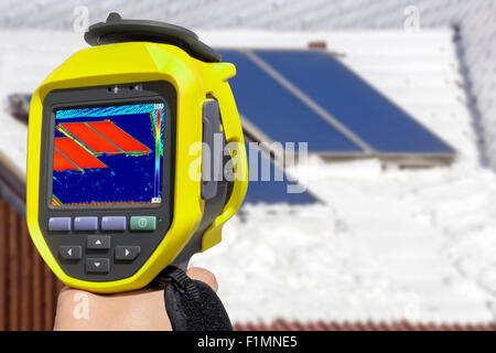 Recording Photovoltaic Solar Panels on the roof House With Thermal Camera Stock Photo