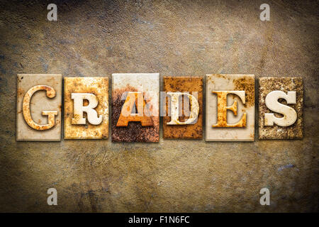 The word 'GRADES' written in rusty metal letterpress type on an old aged leather background. Stock Photo