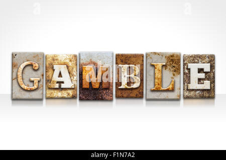 The word 'GAMBLE' written in rusty metal letterpress type isolated on a white background. Stock Photo