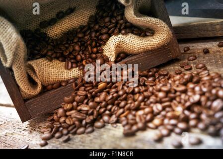 Spilled Coffee Beans on the Old Wood Table. Stock Photo