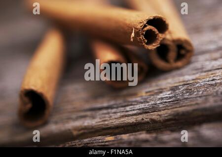 Fresh Aromatic Raw Cinnamon Sticks on Aged Wood. Stock Photo