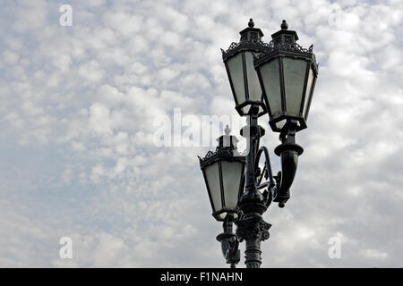 Vintage iron street lamp against the cloudy sky Stock Photo