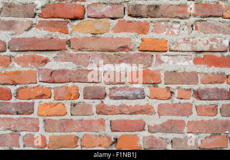 weathered red brick wall with gray mortar Stock Photo