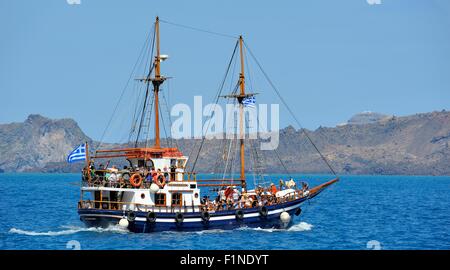 Tourists taking a day trip at sea around the Greek Island of Santorini Greece Stock Photo