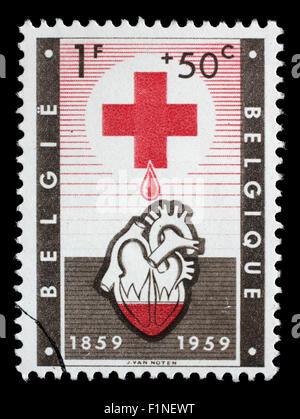 Canceled postage stamp from Belgium illustrating Red Cross, issued in 1959. Stock Photo