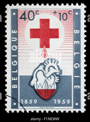 Canceled postage stamp from Belgium illustrating Red Cross, issued in 1959. Stock Photo