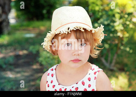 Cute Caucasian little girl in straw hat, outdoor summer portrait